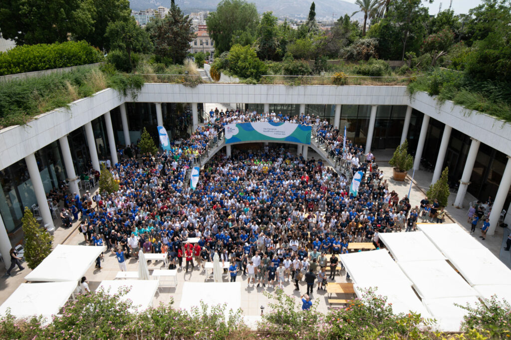 A group photo showing the WordCamp Europe 2023 attendees stood in the courtyard at the venue. 